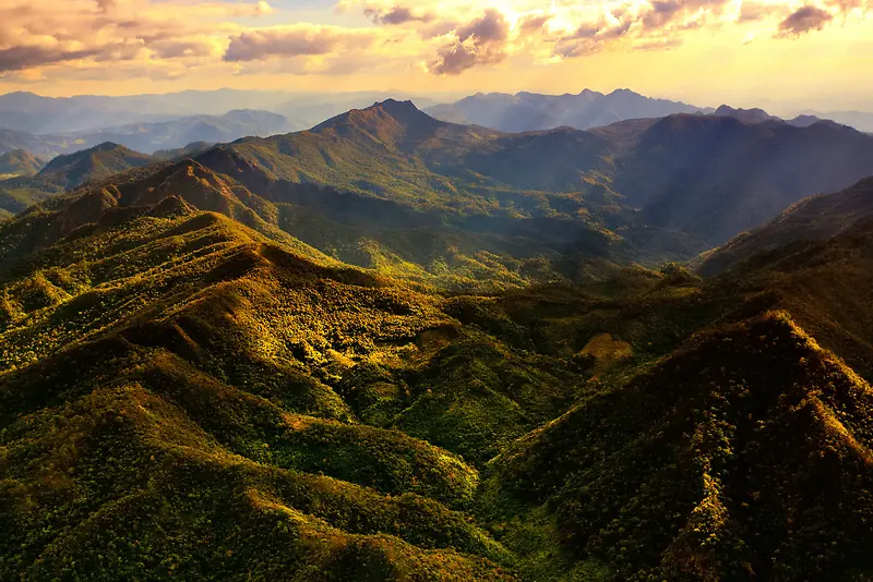 夕阳照射在绿山峰上